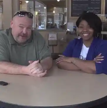 Two people sitting at a table.